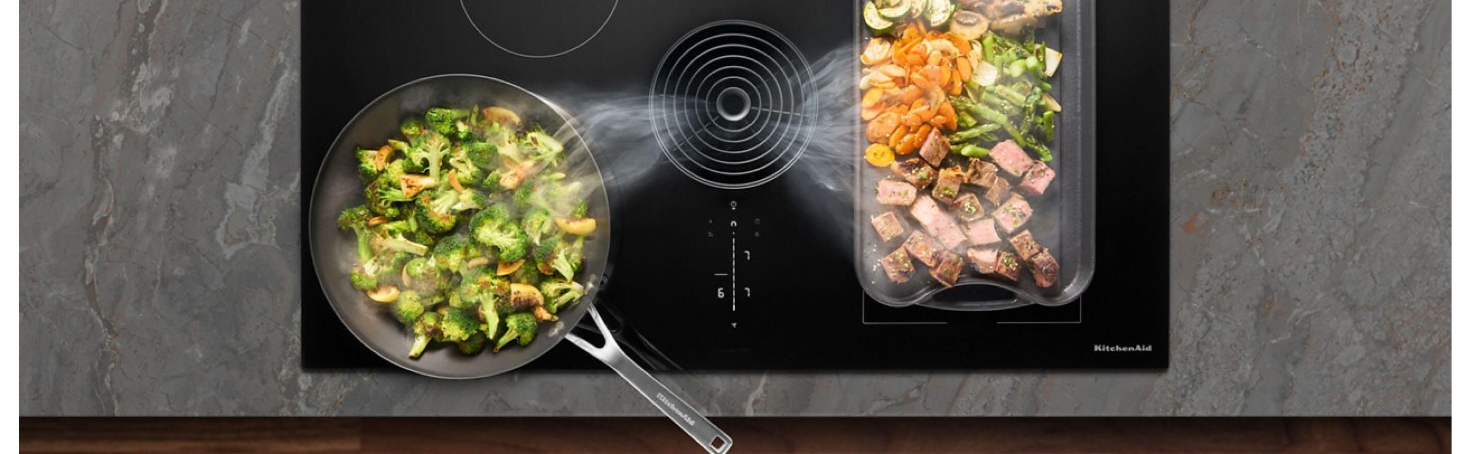 Overhead view of food cooking on an induction cooktop