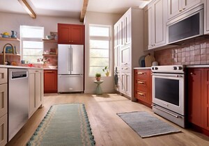 A suite of KitchenAid® stainless steel appliances in a burnt orange kitchen